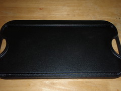 Seasoned cast iron griddle with a patina that is black as night.