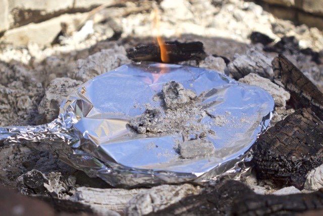 Covering breakfast potato boats with foil while cooking in campfire | Cooking-Outdoors.com | Gary House