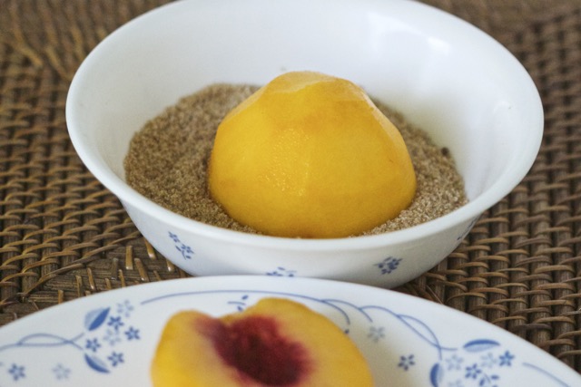 Dipping peaches in brown sugar mixture | Cooking-Outdoors.com | Gary House