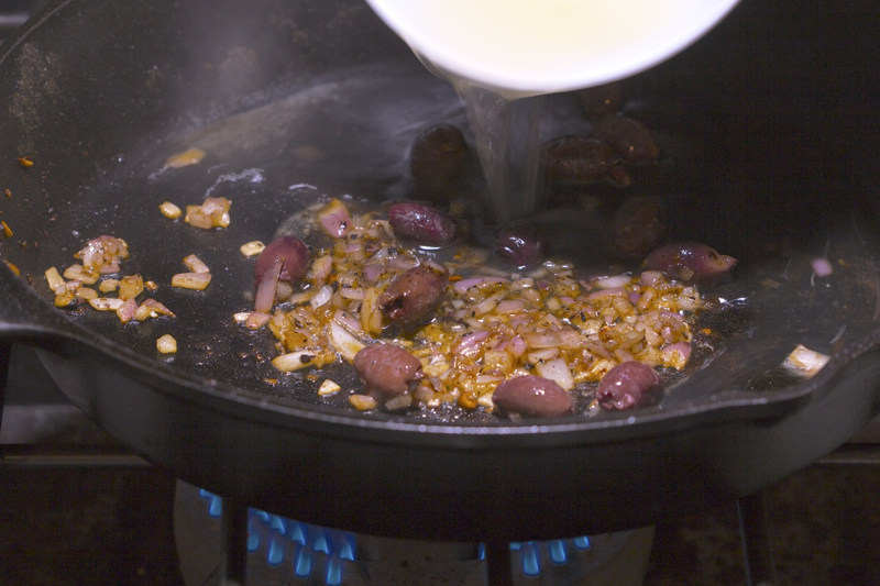 Adding the liquids to the Orange-Olive Chicken Scaloppine Recipe