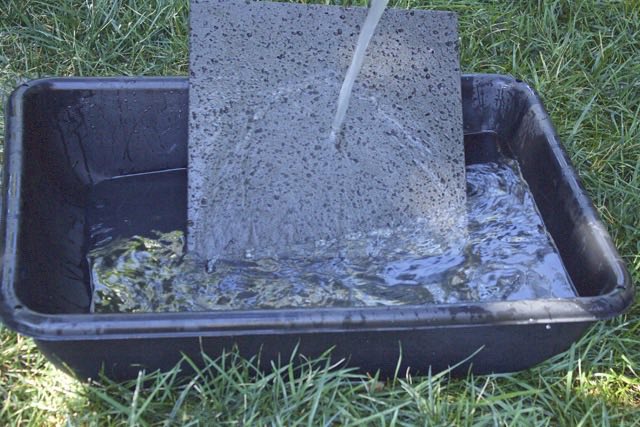 Rinsing the Island Grillstone | Cooking-Outdoors.com | Gary House